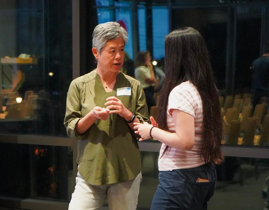 Dr. Ida Sim in conversation with an attendee